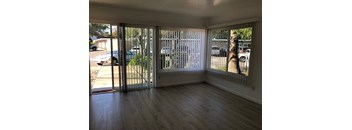 an empty living room with sliding glass doors