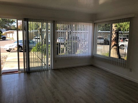 an empty living room with sliding glass doors