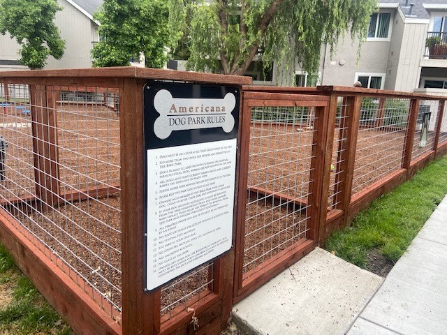 a sign on a fence with a dog in it