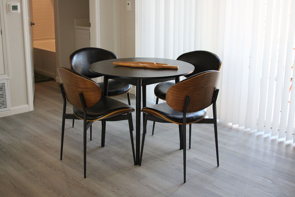 A round table with four chairs around it.