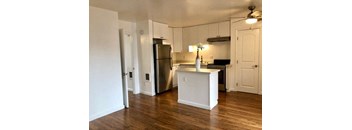 an empty kitchen with a stainless steel refrigerator