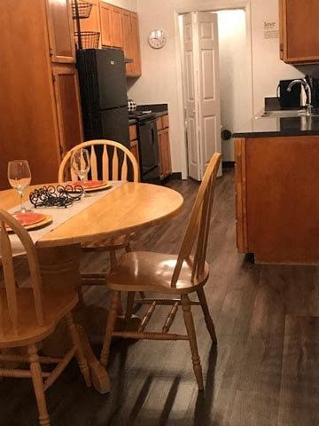 a kitchen with a wooden table and chairs