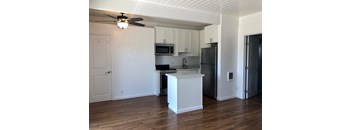 a kitchen with an island and a stainless steel refrigerator