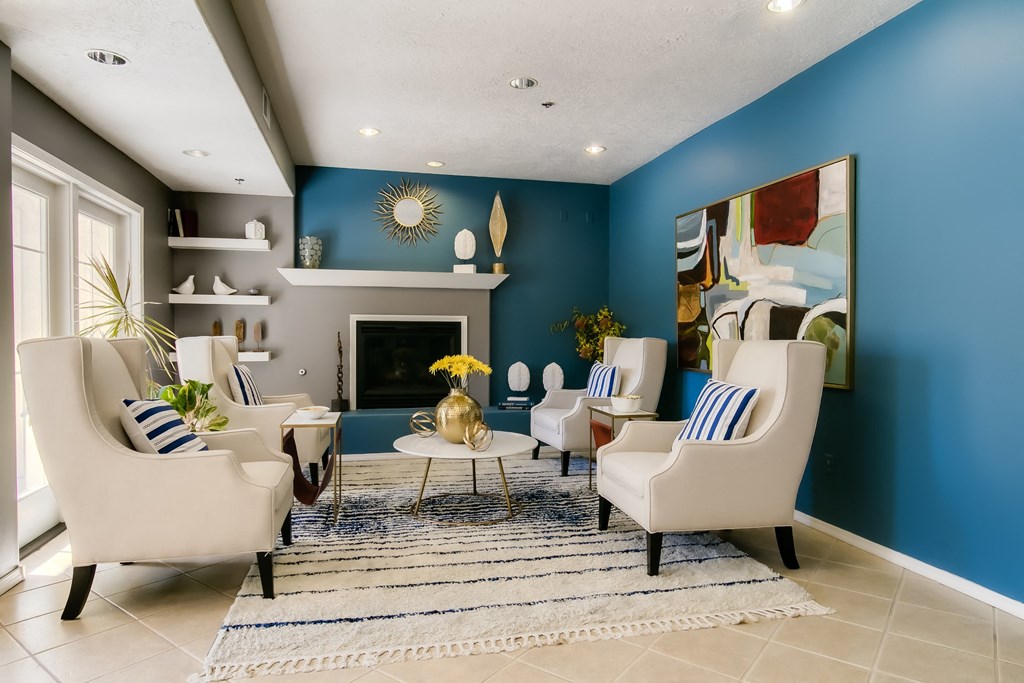 a living room with blue walls and a white tile floor