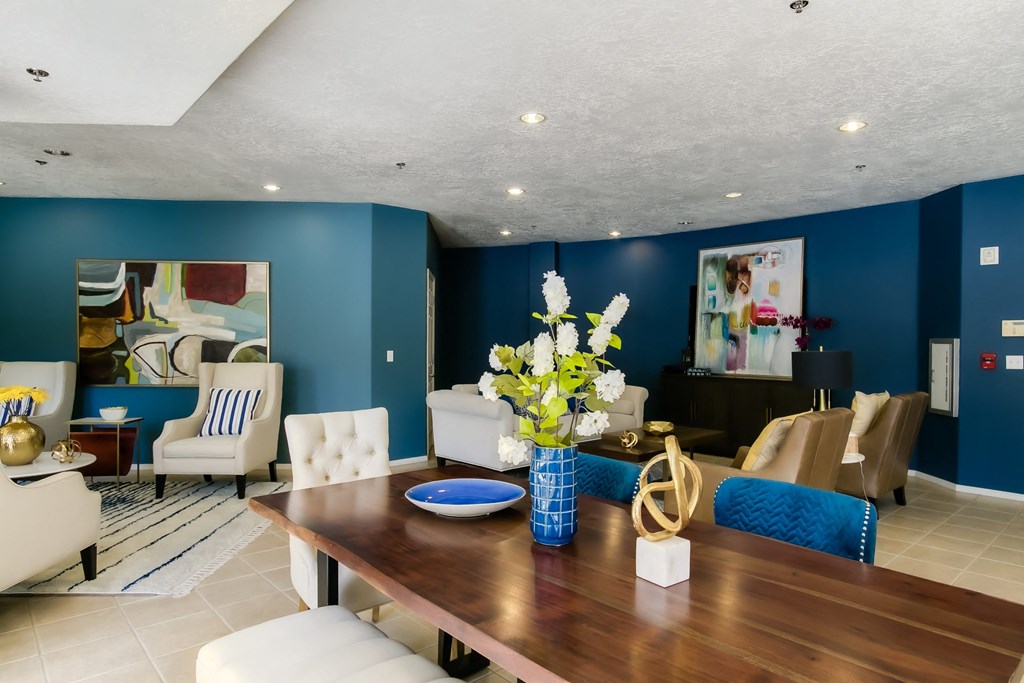 a dining room table with a vase of flowers on top of it