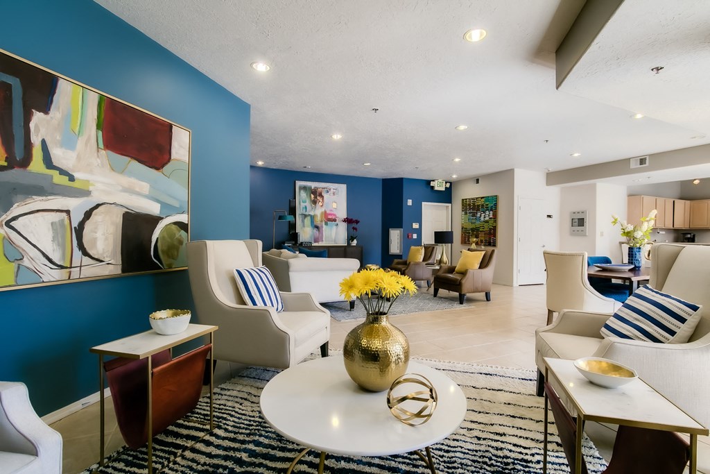 a living room filled with furniture and a large colorful painting