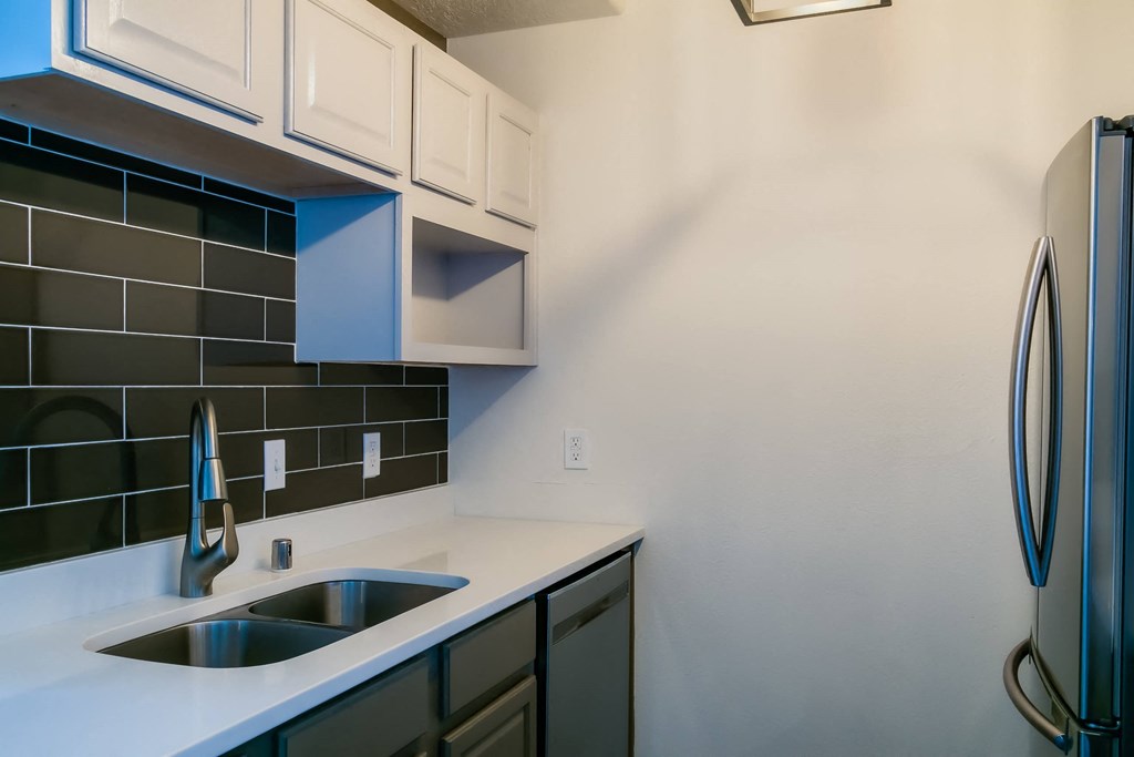a kitchen with a sink and a refrigerator