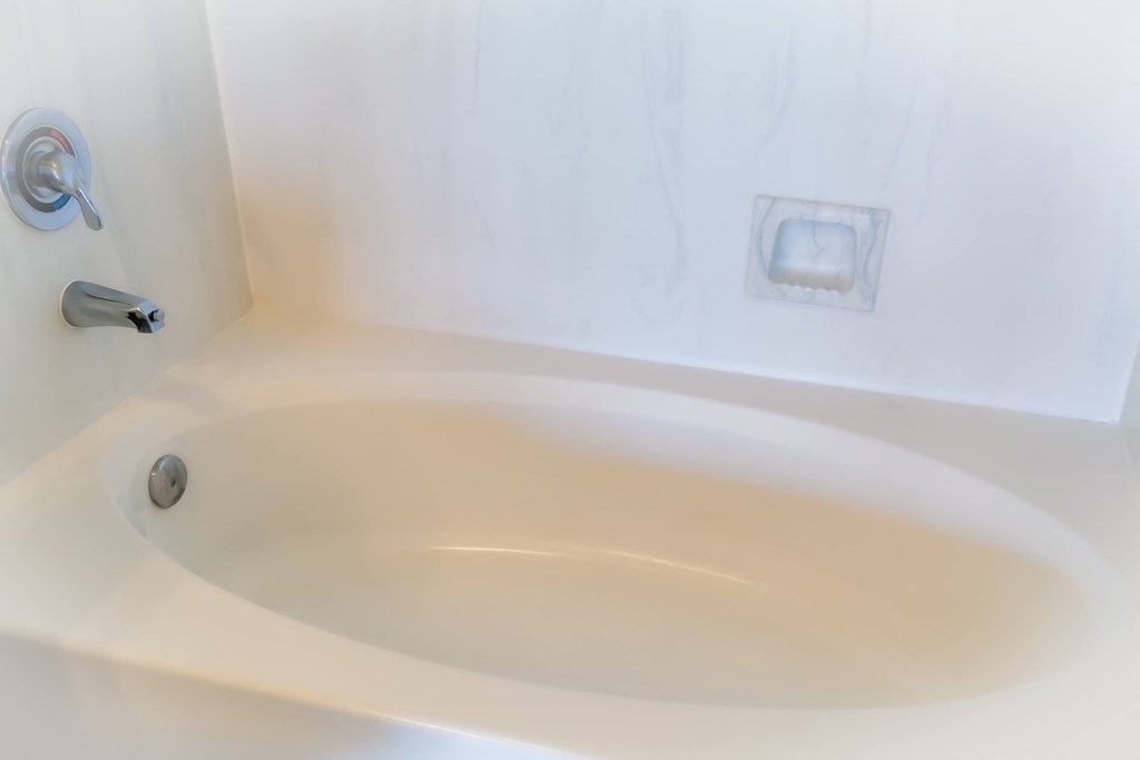 a white bathtub with a silver faucet in a 555 waverly unit