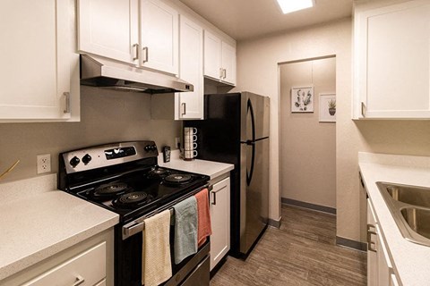 a kitchen with a stove and a refrigerator
