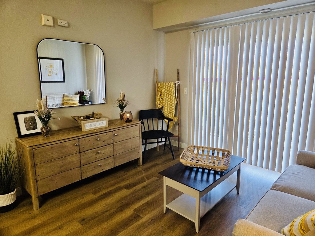 A room with a wooden dresser, mirror, and a chair at Everett Senior Community, Everett, WA