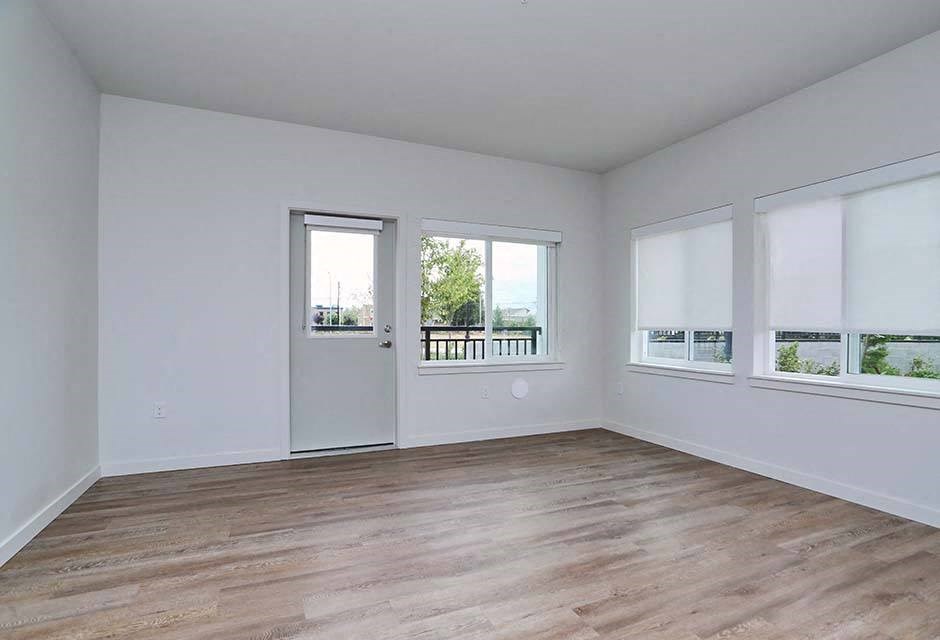 Arlington Senior Living - Spacious Living Room With Hardwood-Style Vinyl Flooring, And Large Windows