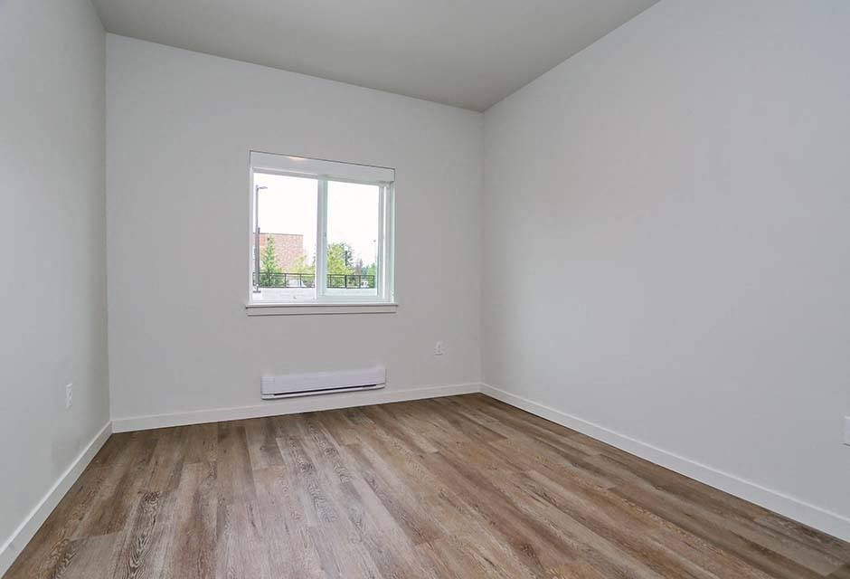 Apartments in Arlington - Cedar Pointe Apartments Bedroom with Large Window and Wood Style Plank Flooring