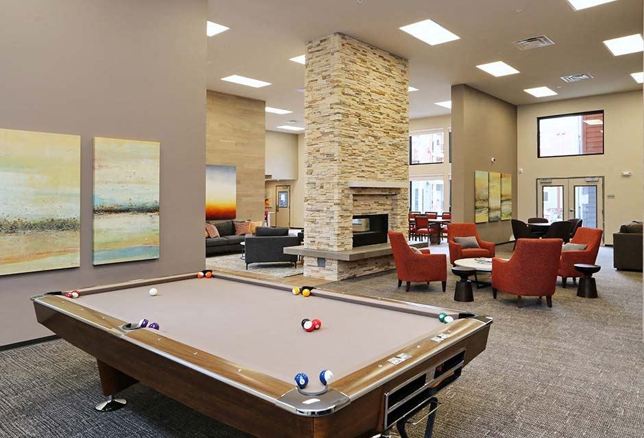 Apartments for Rent in Arlington - Cedar Pointe - Game Room with a Pool Table, a Fireplace, and Various Comfortable Seating Options