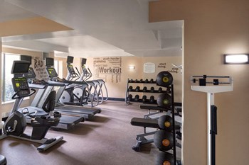 a room filled with lots of different types of exercise equipment - Photo Gallery 5