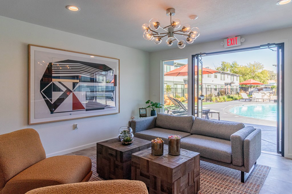 a living room with a view of a pool and a painting