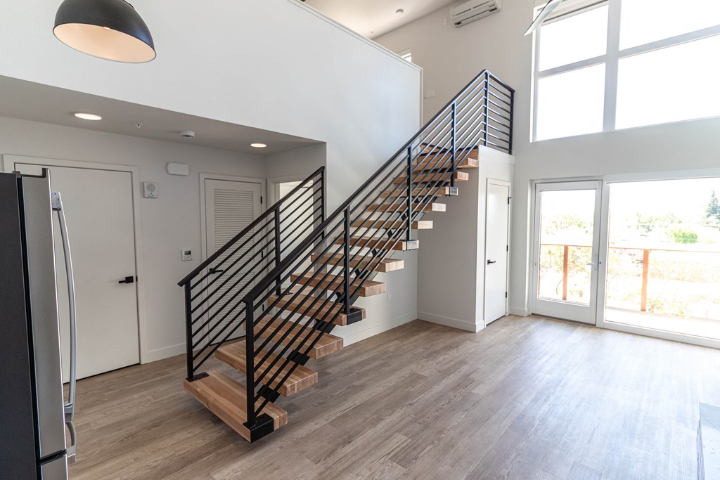 a staircase in a home with wood floors and white walls