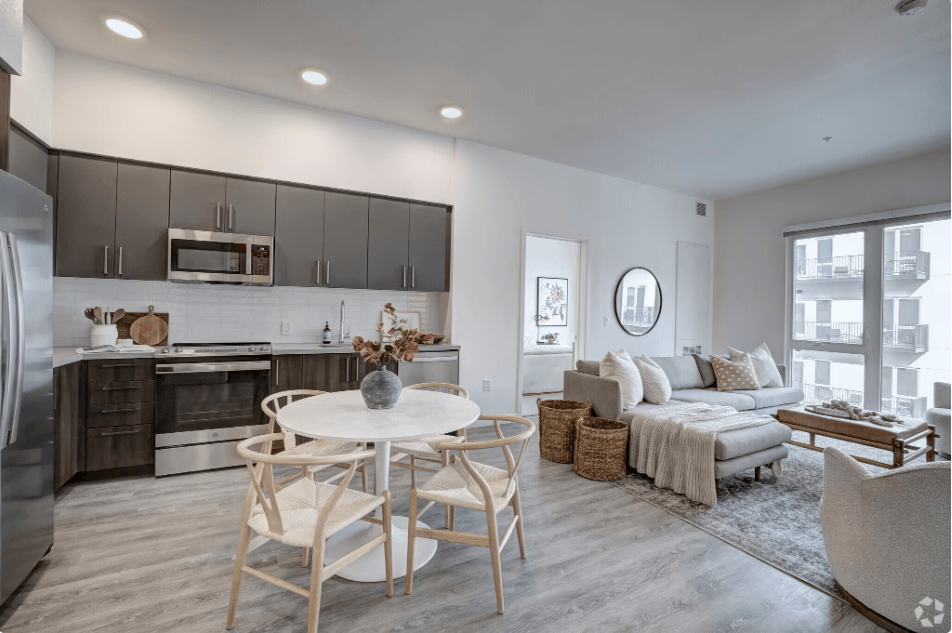 a living room with a kitchen and a couch and a table