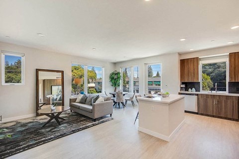 a large living room with a kitchen and a table