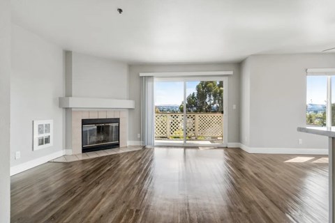 A spacious living room with a fireplace and sliding glass doors.