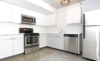 A kitchen with white cabinets and stainless steel appliances at LOFT 205 Apartments, Reno, NV, 89501
