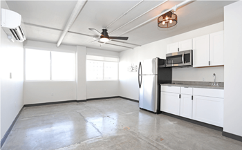 A spacious kitchen with white cabinets and a stainless steel refrigerator at LOFT 205 Apartments, Reno