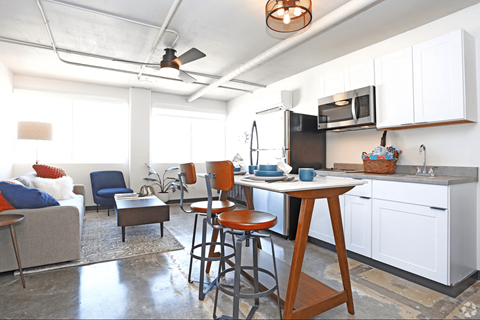 A kitchen with a table and chairs in the middle of the room.