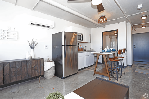 A kitchen with a black fridge and a wooden table at LOFT 205 Apartments, Nevada