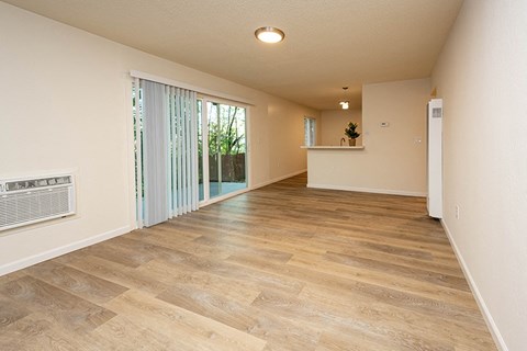 the spacious living room with sliding glass doors to the patio