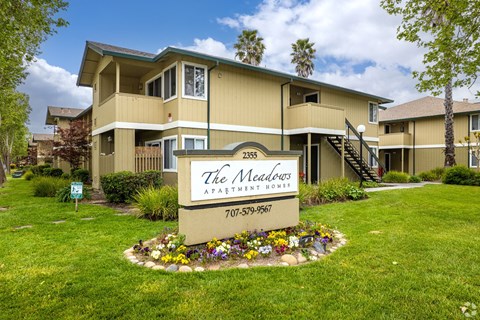the apartments sign in front of grass and flowers at THE MEADOWS, Santa Rosa, CA, 95404