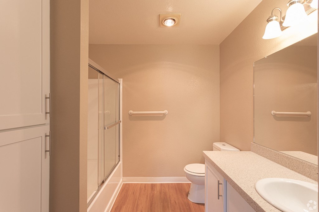 a bathroom with a shower toilet and sink