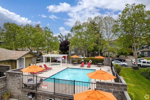a swimming pool with orange umbrellas by pool at THE MEADOWS, California, 95404