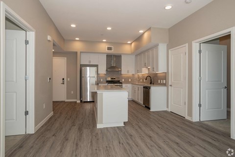 A modern kitchen with white cabinets and a central island.