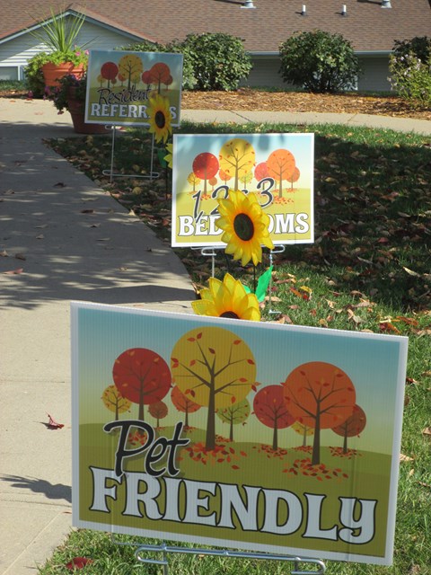 A sign that says Pet Friendly is in front of a house.