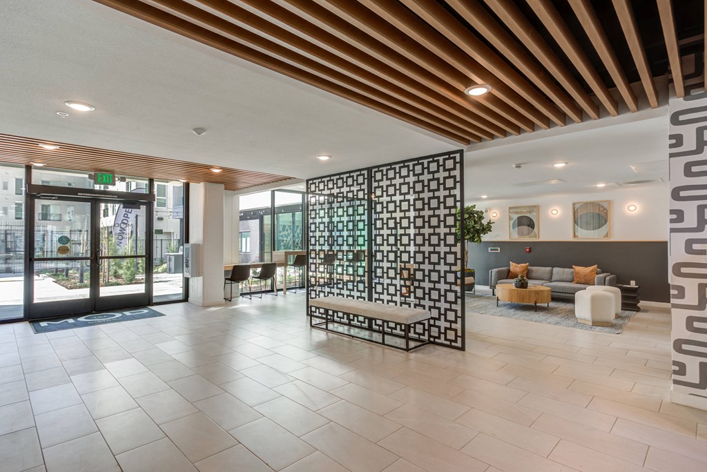 a lobby with a lobby area with a seating area and glass doors