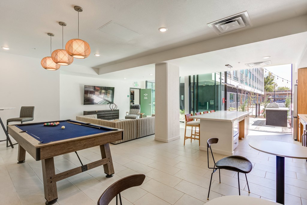 a game room with a pool table and a bar