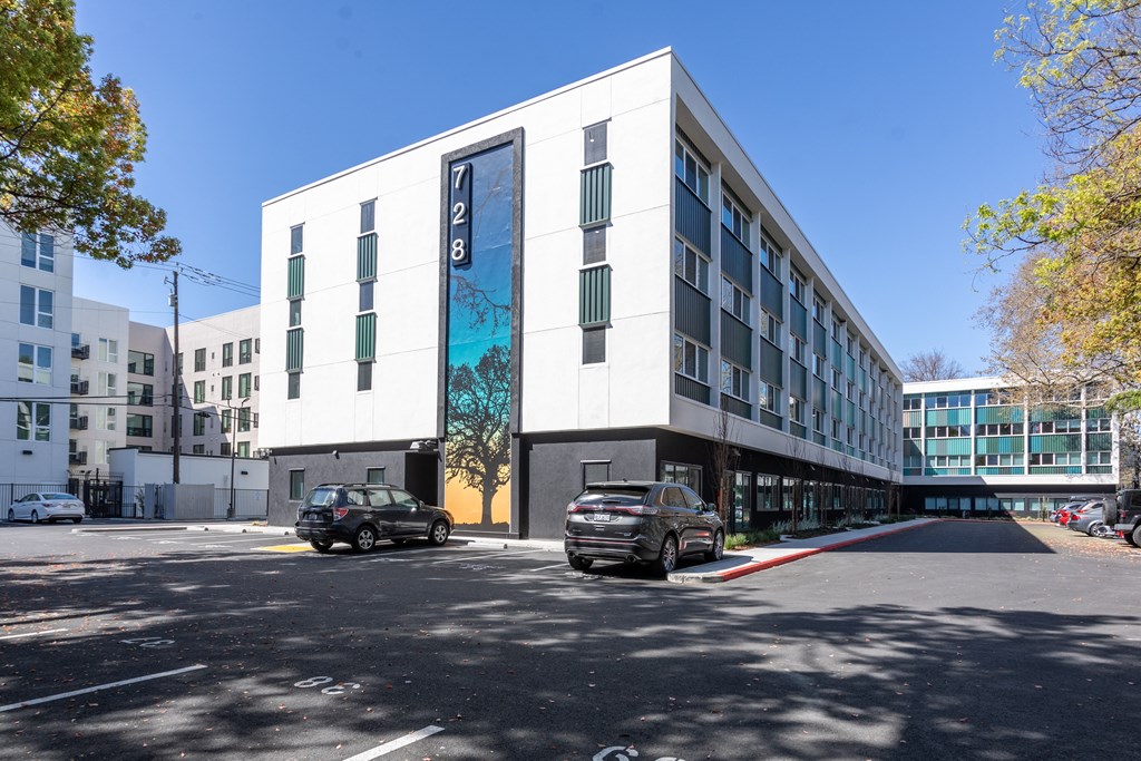 a large white building with a blue mural on the side of it