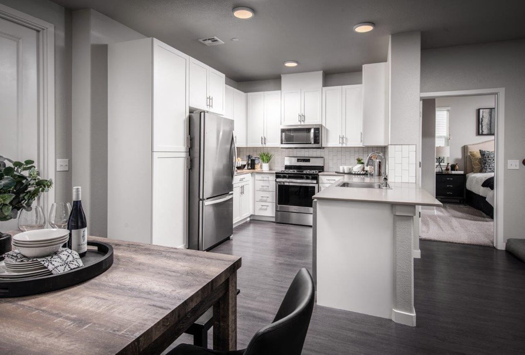 Roseville CA Apartments - Spacious Kitchen Featuring Convenient Stainless Steel Amenities Such as Fridge, Stove, and Microwave