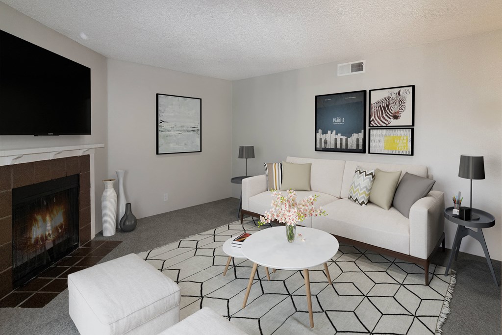 Pet Friendly Apartments in Carmichael CA - Terra Vida - Living Room with Couch, Coffee Table, End Tables, Lamps, Area Rug, and Fireplace.