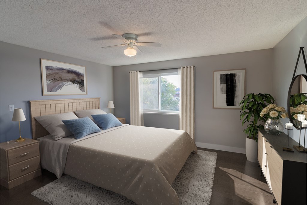 Apartments In Arden Arcade CA - Mode - Spacious Bedroom With A Queen Size Bed, Wood-Style Flooring, A Large Window, And A Ceiling Fan
