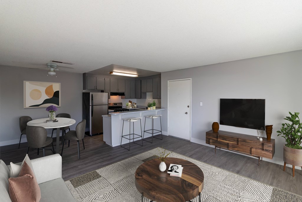 a living room and kitchen with a table and chairs and a television