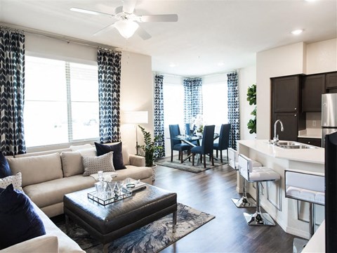 A modern living room with a white sofa and a dark coffee table.