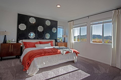a bedroom with a bed and a black and white accent wall