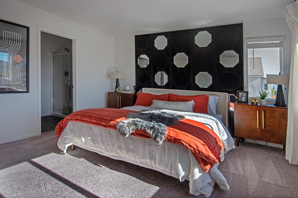 Pet-Friendly Homes In Reno, NV - Aspen Vista At Anchor Pointe - Spacious Bedroom With Carpet Flooring, High Ceilings, A Window With Blinds, And A Bathroom.