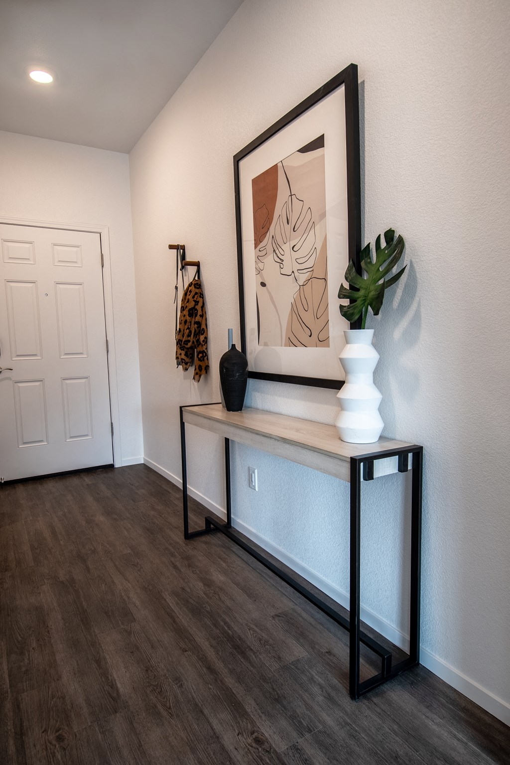 a living room with a table and a picture on the wall