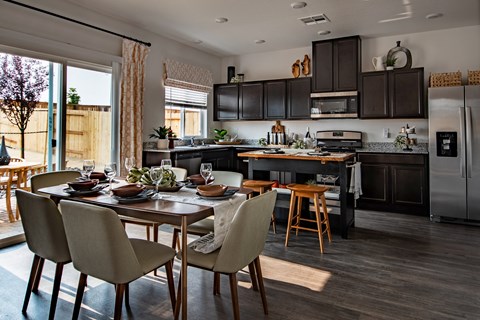 a kitchen and dining room with a table and chairs