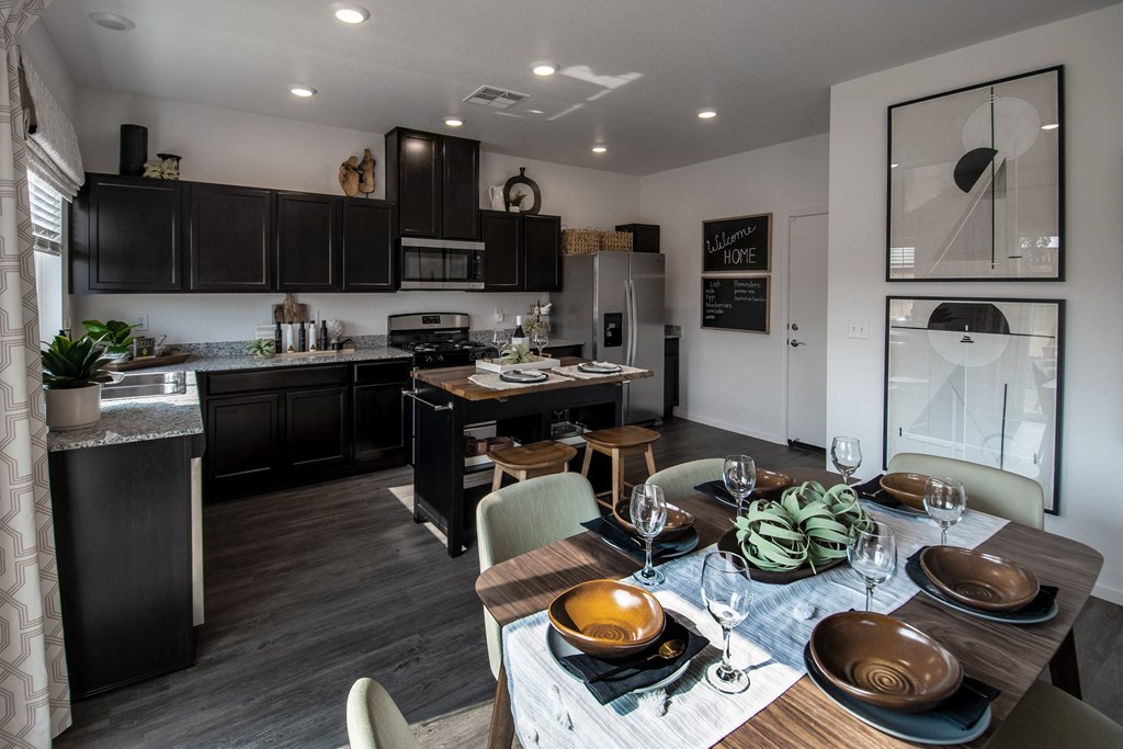 a kitchen and dining room with a table and chairs