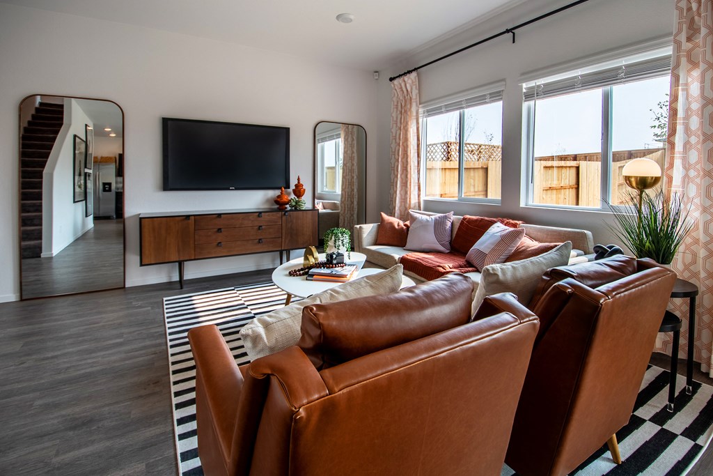 Homes For Rent Reno, NV - Aspen Vista At Anchor Pointe - Living Room With High Ceilings, Vinyl Plank Flooring, And Two Windows With Blinds