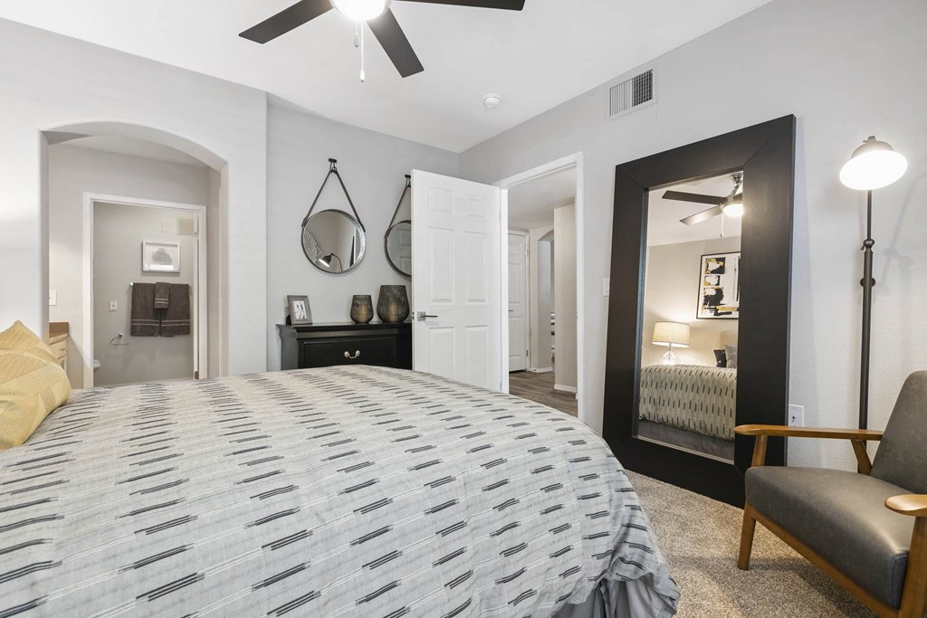 a bedroom with a large bed and a mirror at Ascent Apartments, Cottonwood Heights, 84121