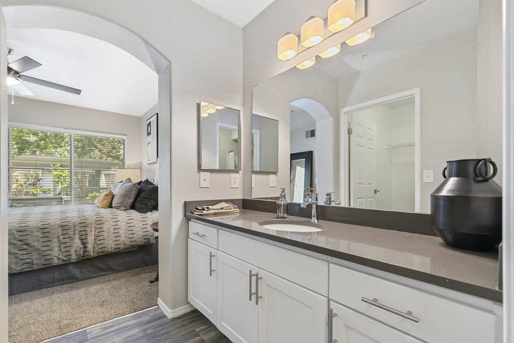a white bathroom with a large mirror and a sink at Ascent Apartments, Cottonwood Heights