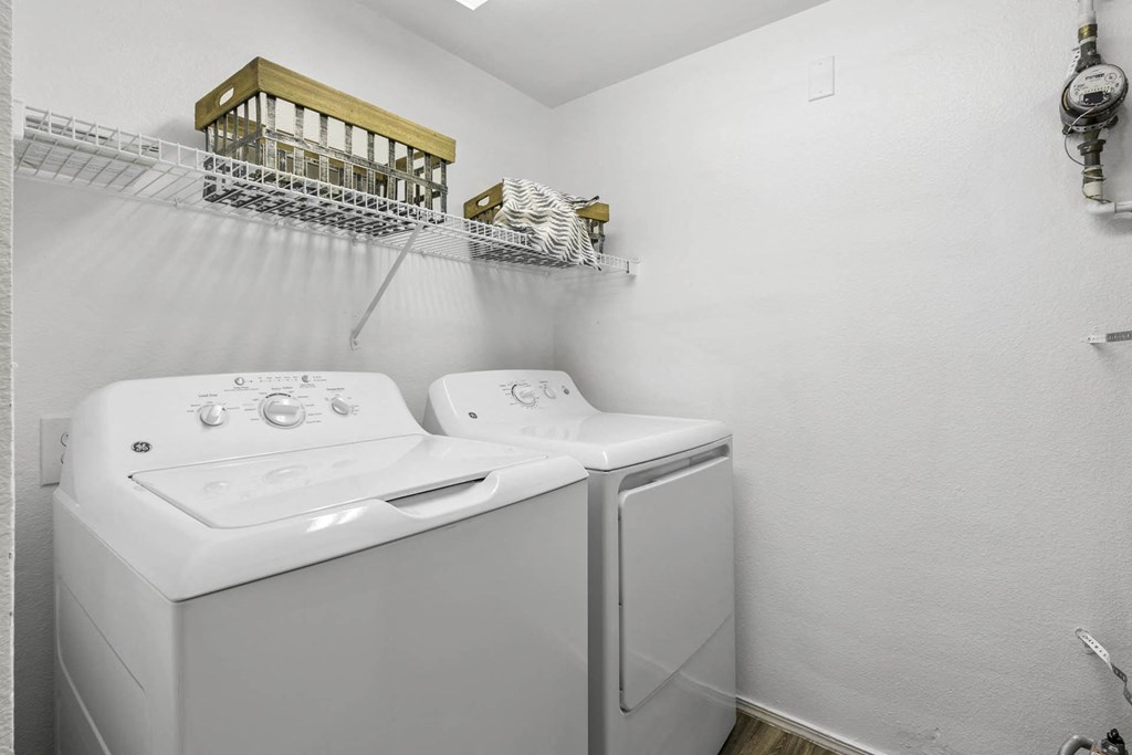 a white laundry room with a washer and dryer at Ascent Apartments, Utah